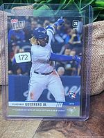 Front of 2019 Topps Now Vladimir Guerrero Jr. rookie card in plastic case showing action photo and RC logo