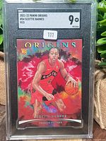 Front view of graded Scottie Barnes red parallel card in SGC slab