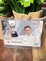 Front of Oscar Piastri Topps F2 card in holder showing image, card number 93, serial 5/55