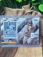 Front view of sleeved card displaying Lou Gehrig patch and Tatis Jr. image
