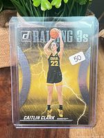 Front of sleeved Caitlin Clark Raining 3s card
