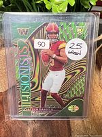 Front of card in sleeve/top loader showing player image and green parallel design