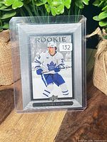Front view of card in top loader showing ROOKIE header and player image