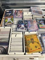 Open card box showing sleeved modern baseball cards, examples of rookies and refractors