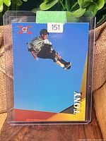Front of card in protective toploader showing Tony Hawk mid-air