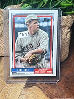 Front of Babe Ruth Topps card in plastic holder showing image and number sticker 164