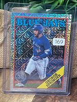 Front view of George Springer refractor card in top loader