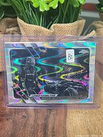 Front of card in sleeve showing RayWave refractor pattern and player image