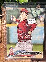 Front of Shohei Ohtani card showing custom anime artwork, RC logo, lot sticker