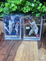 Front view of both sleeved cards in top loaders