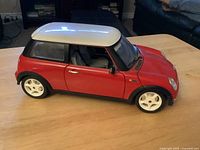 Side view of red 1:8 scale Mini Cooper model car