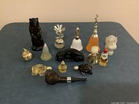Group shot of all fourteen novelty Avon bottles