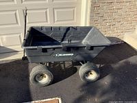 Full view of Gorilla Carts dump cart showing tub, handle, wheels