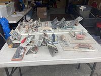 overview of all 37 concrete trowels and floats spread on table