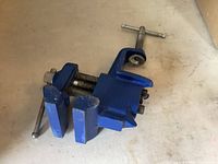 Side view of blue Irwin clamp-on vise showing jaws and mounting screw