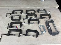 All 12 C-clamps laid out showing size variation
