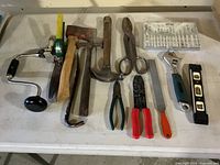 Overall view of all 13 hand tools laid out on table