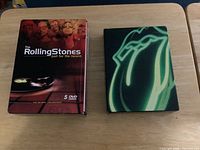 Two Rolling Stones DVD box sets on table