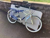 Full view of Schwinn men's bicycle leaning against wall