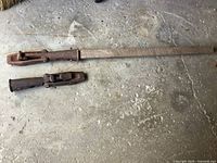 Two railroad car movers side by side on floor, showing overall sizes and handle presence