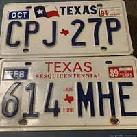 Fronts of both Texas license plates showing designs and stickers