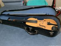 Violin inside black hard case with bow