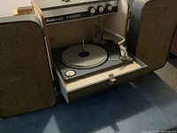 Front view of Fleetwood suitcase record player with speakers opened and platter visible