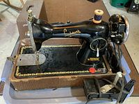 Full view of Simpson's Model 15A sewing machine on case base with foot pedal