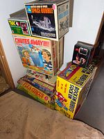 Stacked view of eight vintage boxed games
