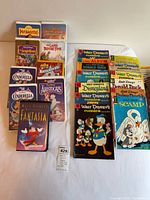 Overview of comics and VHS tapes laid out on bed