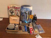 All items laid out including sealed shavers, pocket tools, fragrance, keychains