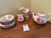 Full view showing teapot, stacked cups, saucers, dessert plates, creamer, sugar bowl