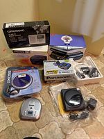 Overview of boxed and loose electronics on floor