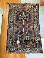 Full view of rug displaying overall design, borders, fringe and size sticker