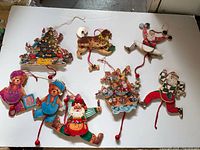 Group shot of all eight wooden pull-string decorations