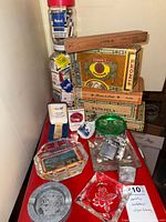 Overall view showing jar of matchbooks, cigar boxes, ashtrays and lighters
