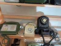 All three telephones on shelf