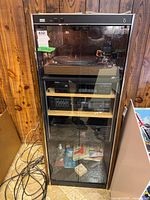 Front view of rack showing wood finish, glass doors, turntable and Yamaha components