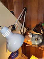Lamp, vise and plane on shelf