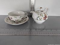 Full set shown with rulers for scale: teacup on saucer and teapot with lid