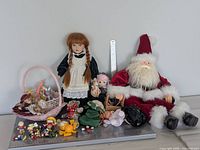 Full lot showing Santa doll, porcelain doll, basket and assorted small items