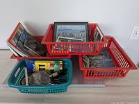 Overview showing four baskets with booklets, postcards, magnifiers, pens