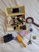 Overall view of open travel case and surrounding grooming items