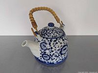 Teapot front view with lid and bamboo handle