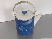 Front view of ceramic teapot with lid and swing handle
