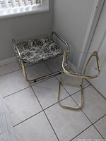 Stool and magazine rack frame side by side showing scale, finish and upholstery