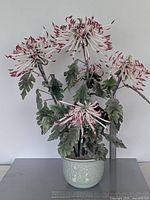 Full view of hardstone chrysanthemum arrangement in celadon pot, ruler for scale