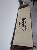 Full view of hanging scroll unrolled on furniture