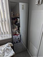 Tall full-length mirror leaning against wall