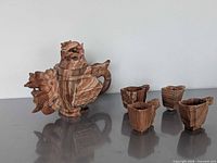 Full view of teapot with lid and four cups